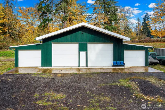a view of a house with a yard and garage