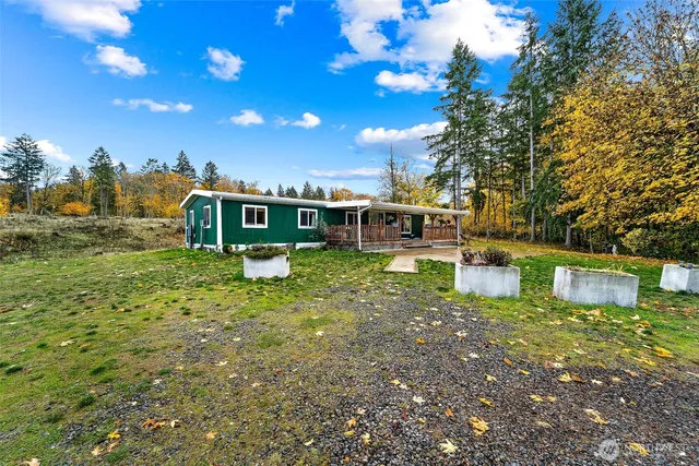 a view of a house with swimming pool and sitting area