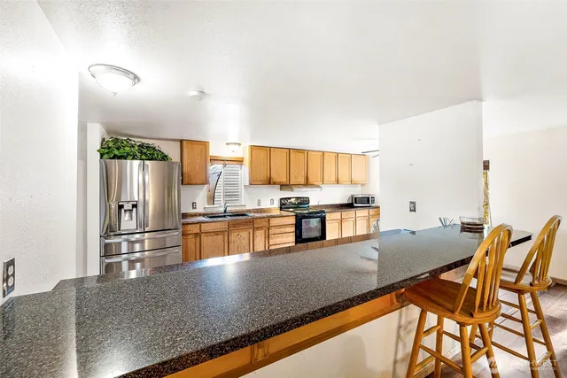 a kitchen with stainless steel appliances granite countertop a sink counter space and stainless steel appliances