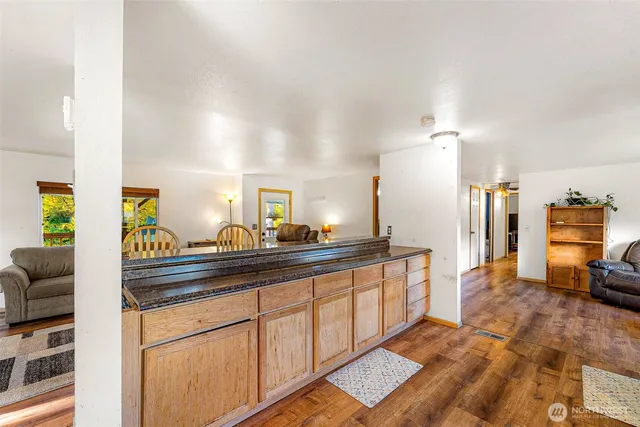 a kitchen with stainless steel appliances granite countertop a sink and a refrigerator