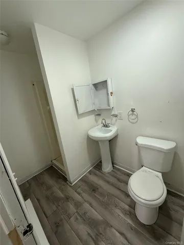 a white toilet sitting next to a white sink