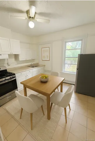 a kitchen with a table chairs and a stove