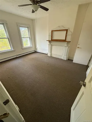 a view of room with window and hardwood floor