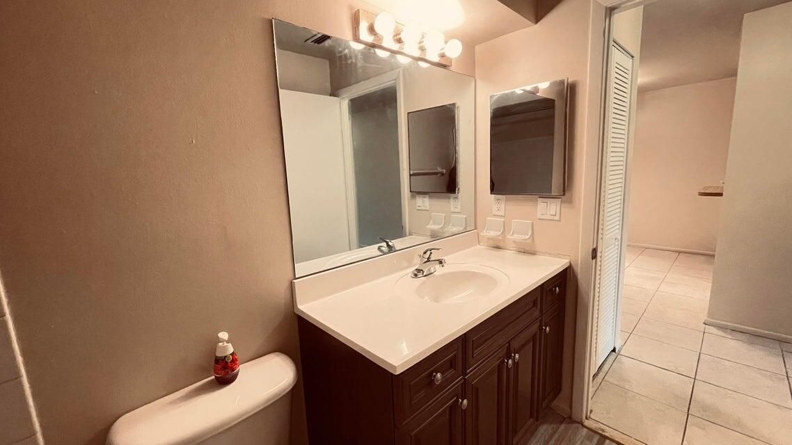 6026 Indrio Road, Unit N6 Fort Pierce, FL 34951 - Photo 33 of 34 a bathroom with a sink and a mirror