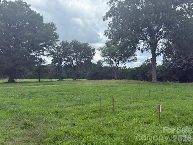 a view of field with trees in the background