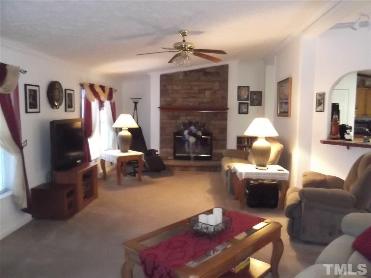 299 J C Lunsford Road Roxboro, NC 27574 - Photo 8 of 25 a living room with furniture and a fireplace