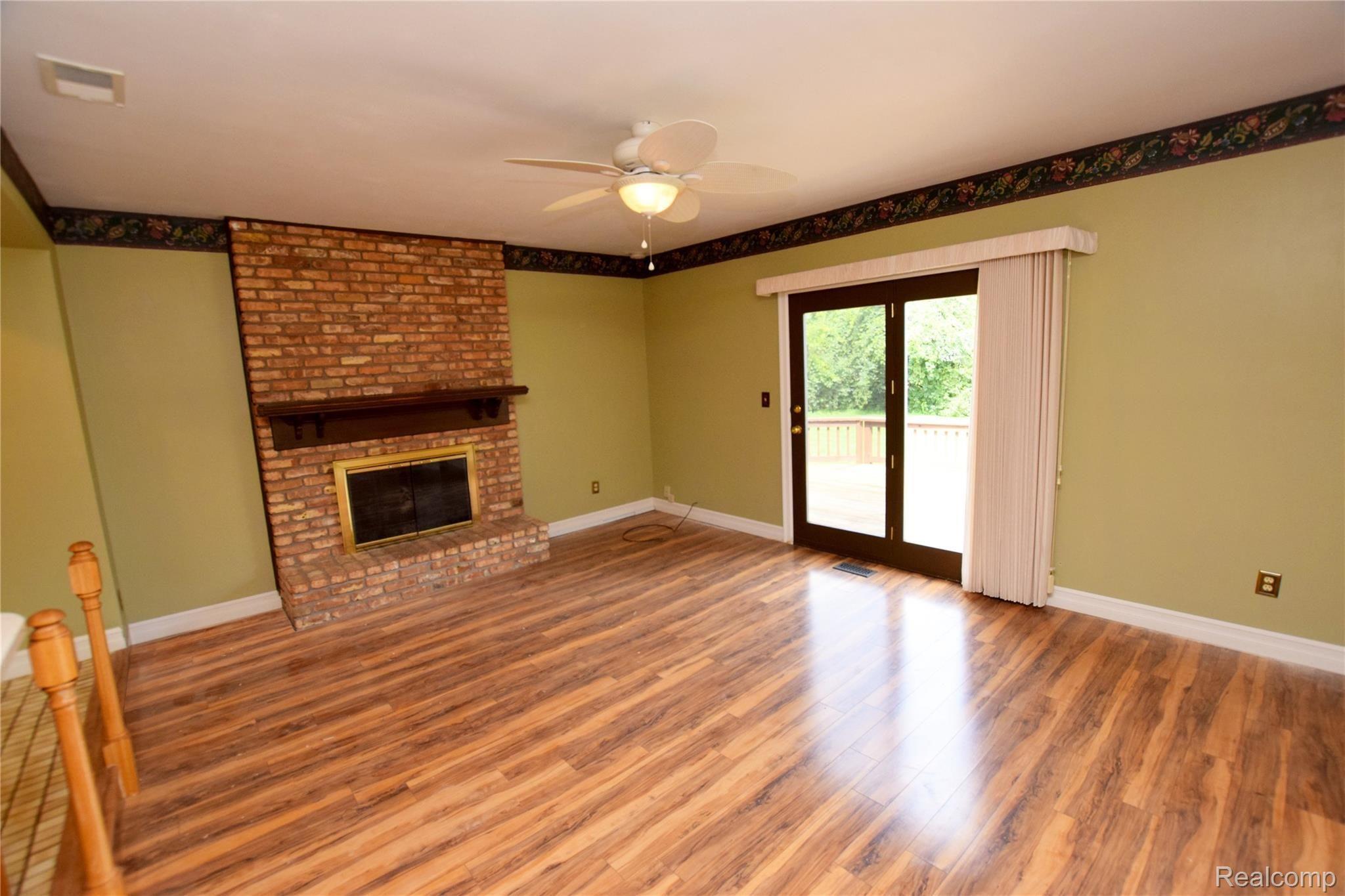 6368 Yorkshire North Riding Road Flint, MI 48532 - Photo 4 of 15 Living Room with Brick Fireplace