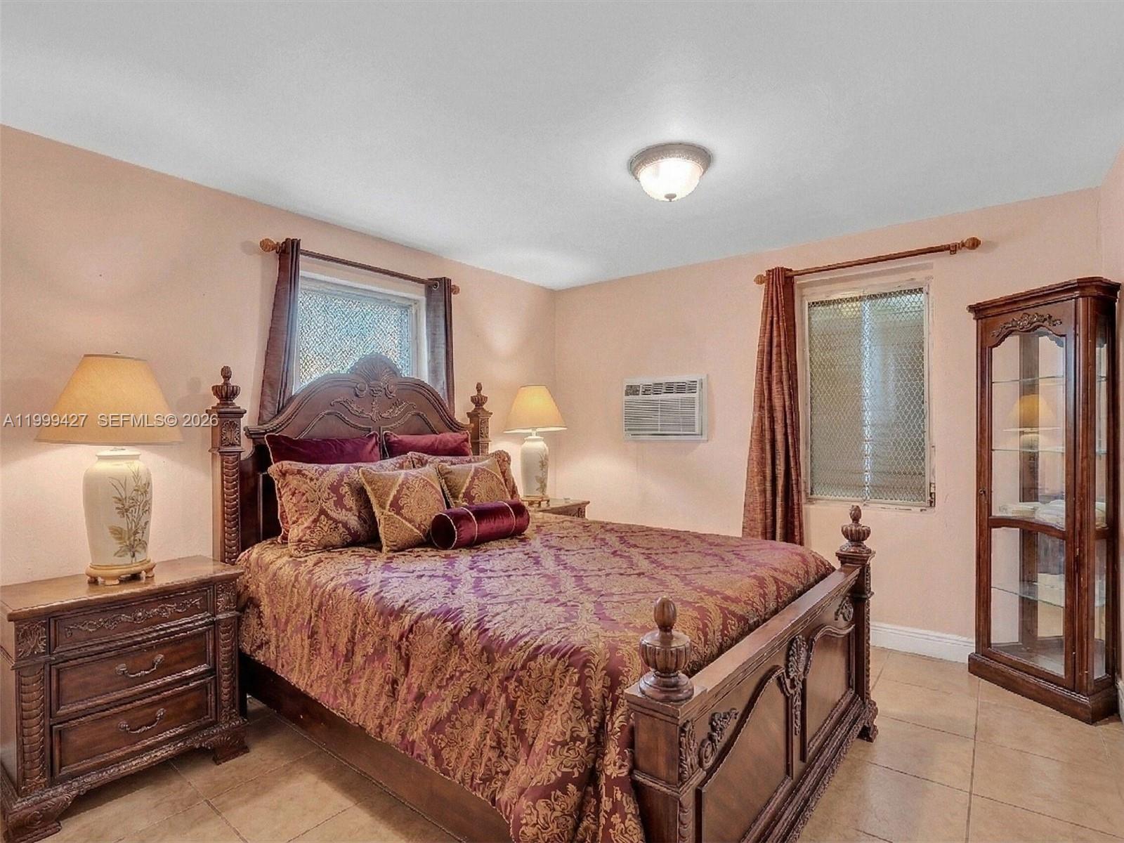 10 Southwest 72nd Avenue Miami, FL 33144 - Photo 15 of 35 a bedroom with a bed and wooden floor