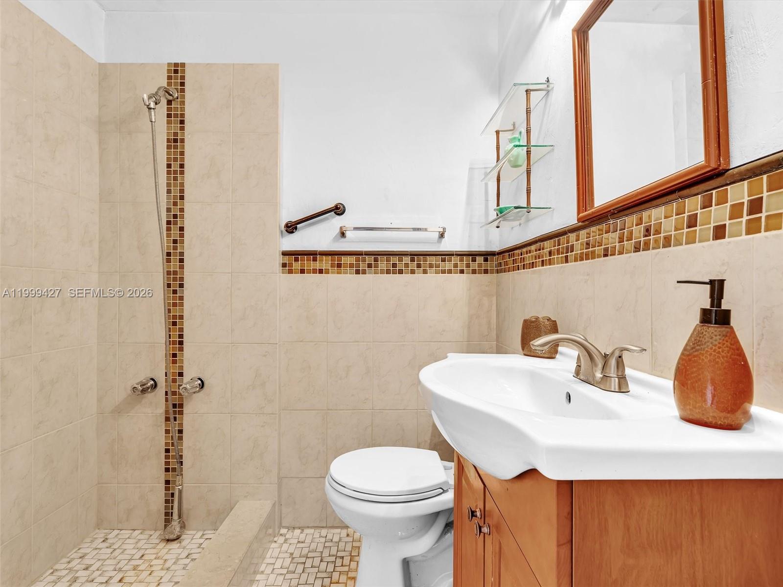 10 Southwest 72nd Avenue Miami, FL 33144 - Photo 17 of 35 a bathroom with a sink a toilet and shower