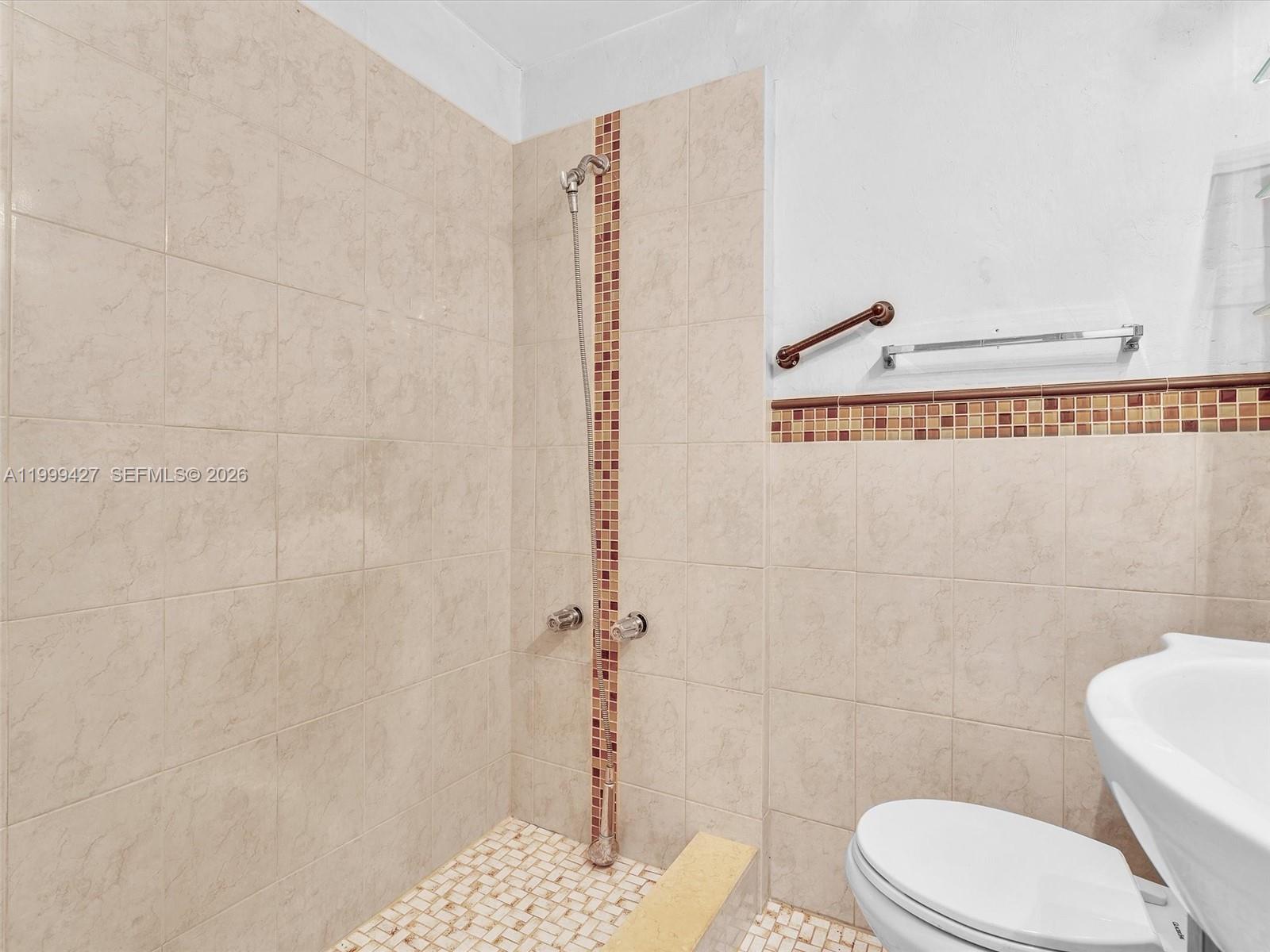 10 Southwest 72nd Avenue Miami, FL 33144 - Photo 18 of 35 a bathroom with a white toilet and a shower