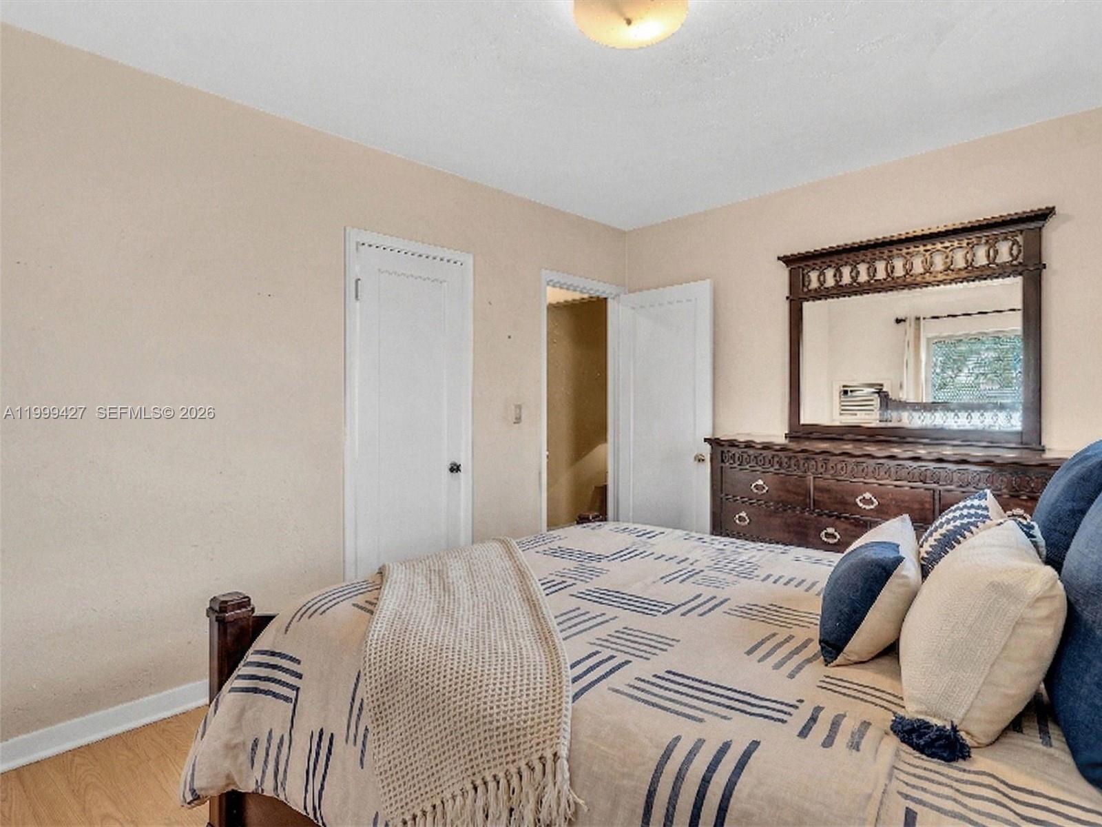 10 Southwest 72nd Avenue Miami, FL 33144 - Photo 20 of 35 a bedroom with a bed and dresser with mirror