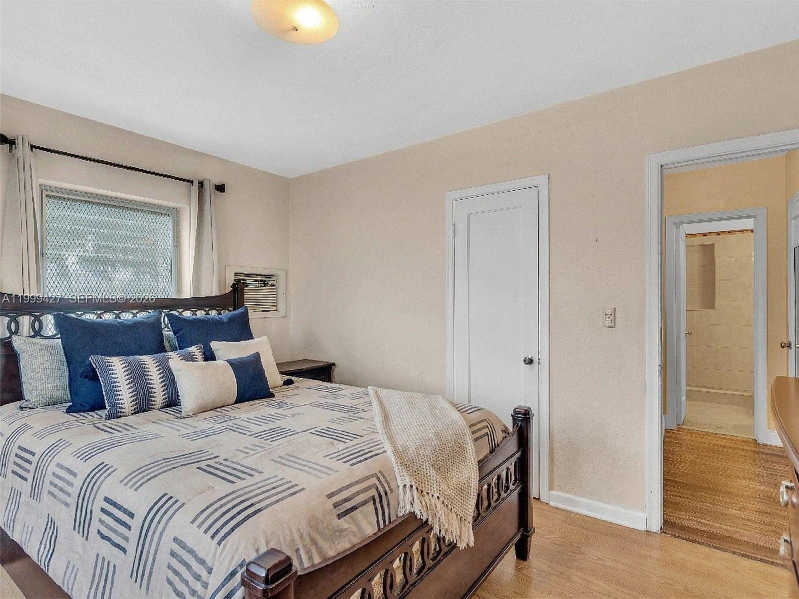 10 Southwest 72nd Avenue Miami, FL 33144 - Photo 21 of 35 a bedroom with a bed and wooden floor