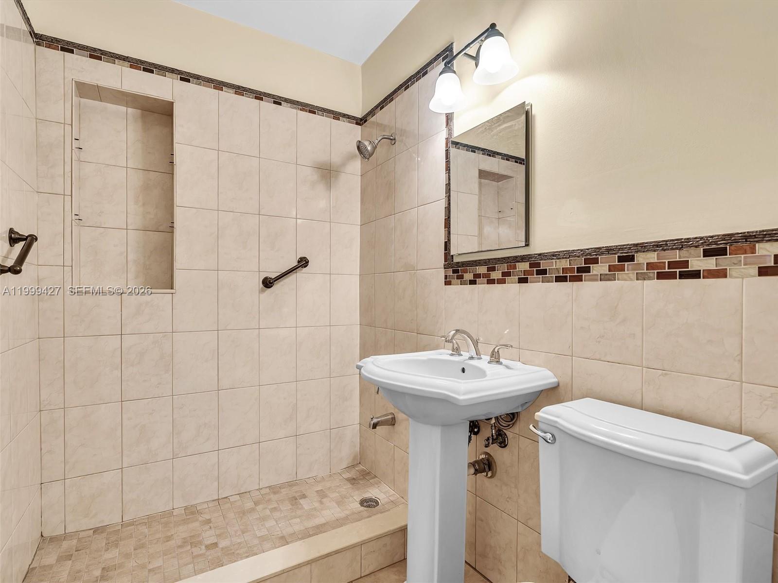 10 Southwest 72nd Avenue Miami, FL 33144 - Photo 23 of 35 a bathroom with a sink mirror toilet and shower