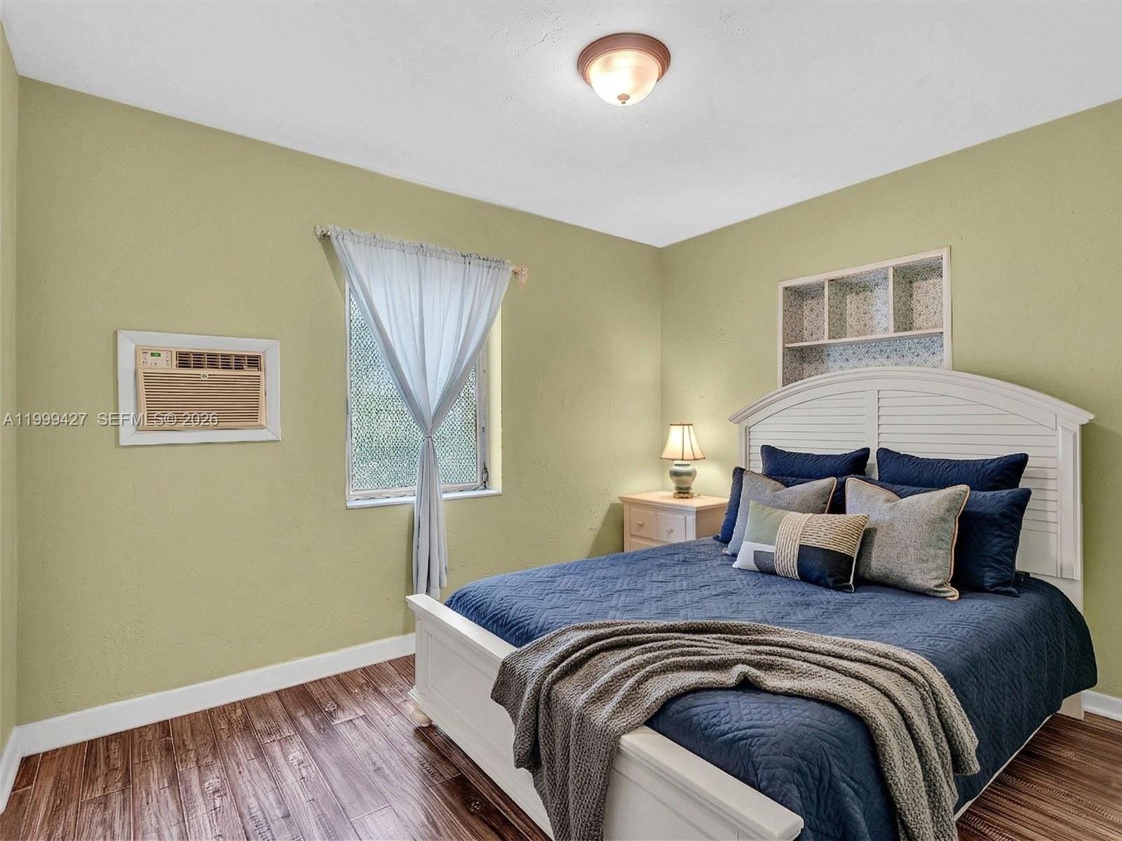 10 Southwest 72nd Avenue Miami, FL 33144 - Photo 24 of 35 a bedroom with a bed and wooden floor