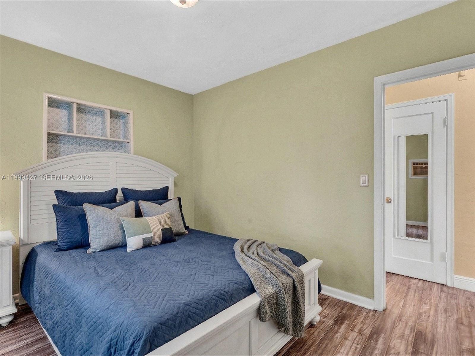 10 Southwest 72nd Avenue Miami, FL 33144 - Photo 26 of 35 a bedroom with a bed and wooden floor
