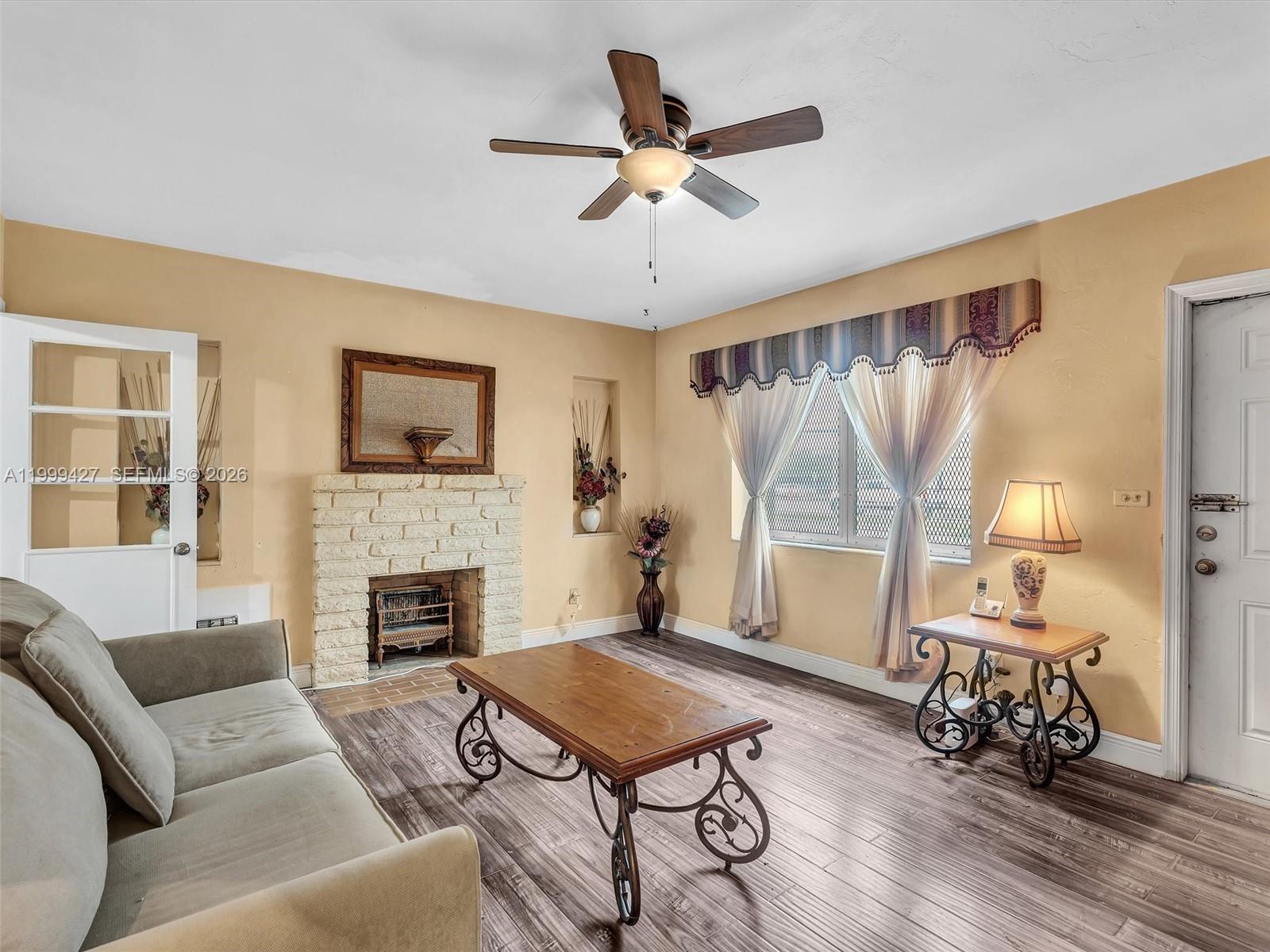 10 Southwest 72nd Avenue Miami, FL 33144 - Photo 5 of 35 a living room with furniture fireplace and a window