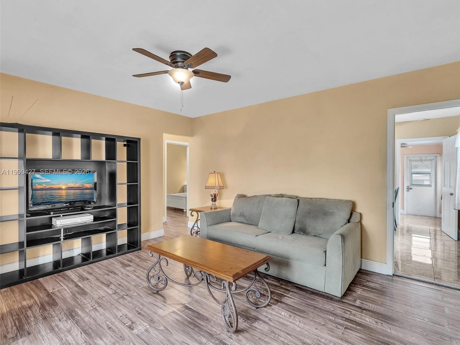 10 Southwest 72nd Avenue Miami, FL 33144 - Photo 7 of 35 a living room with furniture and a flat screen tv
