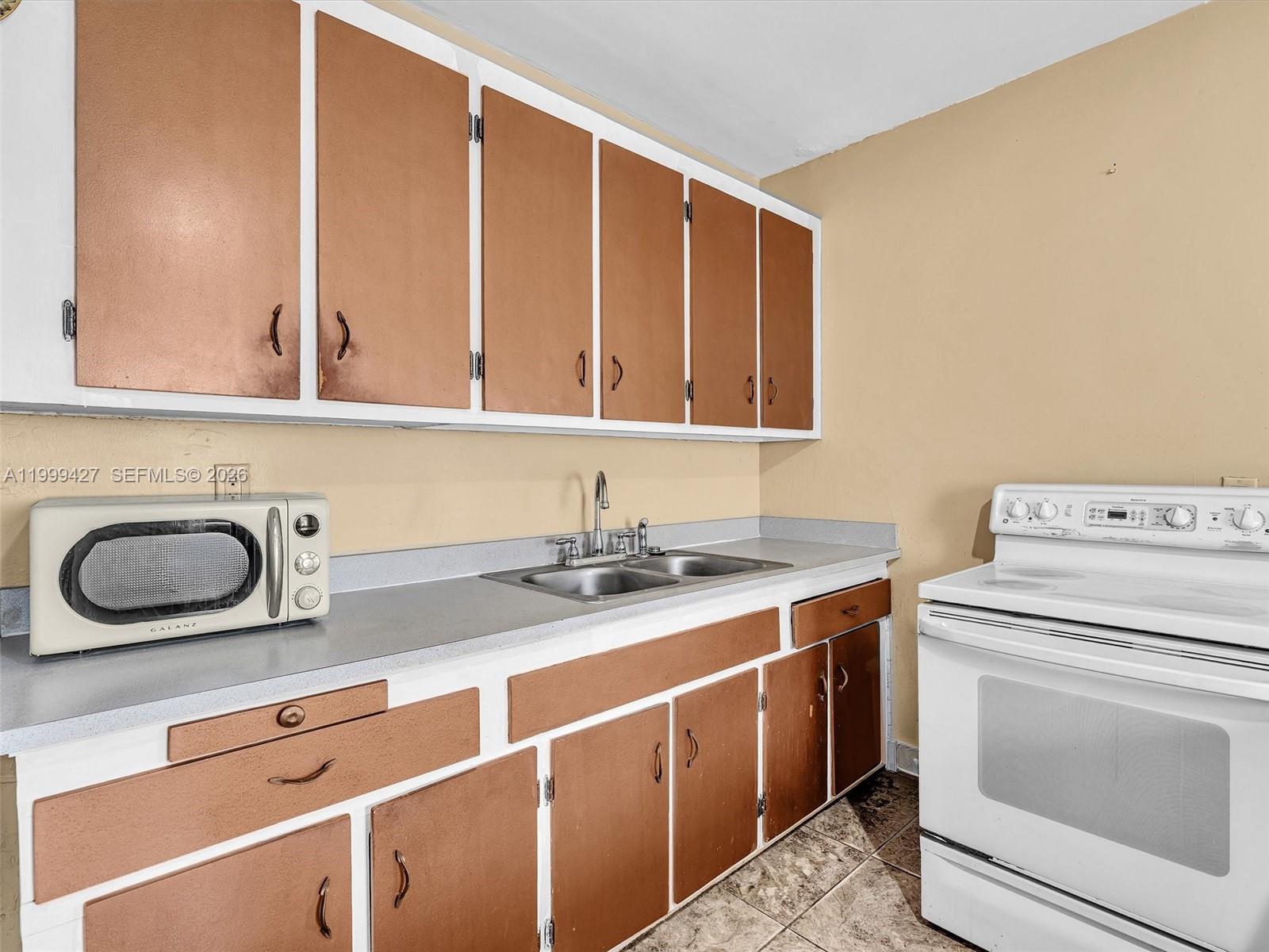 10 Southwest 72nd Avenue Miami, FL 33144 - Photo 10 of 35 a kitchen with a stove and a sink