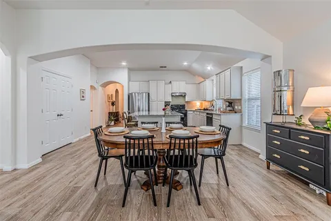 a view of a dining room with furniture and wooden floor