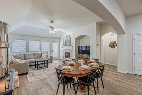 a view of a a dining room with furniture window and wooden floor