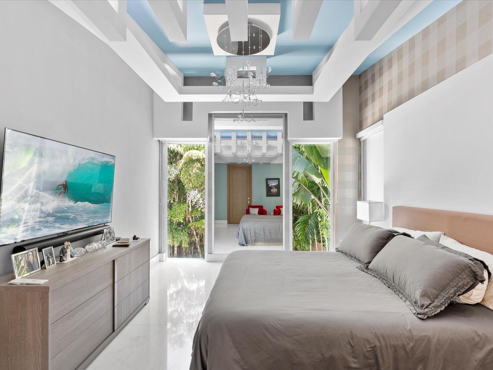 3917 South Le Jeune Road Miami, FL 33146 - Photo 74 of 91 a bed sitting in a bedroom next to a window