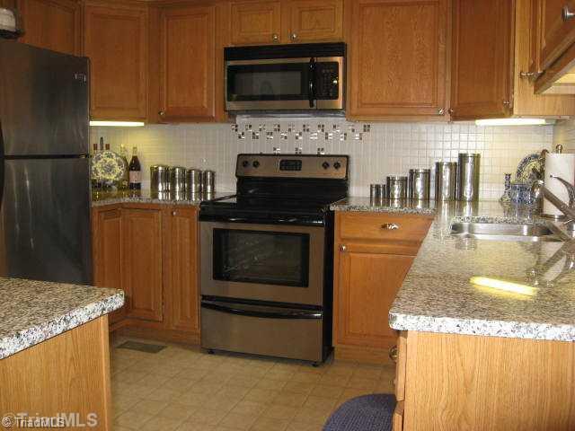 3500 Edgefield Road Greensboro, NC 27409 - Photo 4 of 16 Kitchen. Granite Counters, tile backsplash and a work island...