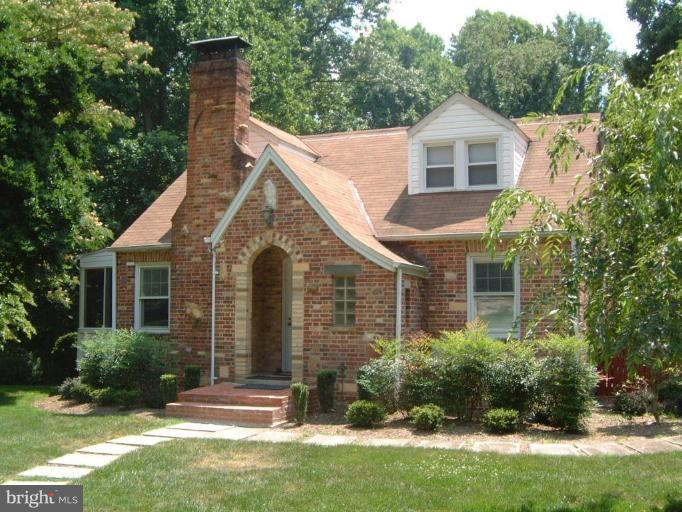 13919 Overton Lane Silver Spring, MD 20904 - Photo 1 of 16 a view of a yard in front of a house with plants and large tree