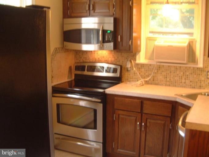 13919 Overton Lane Silver Spring, MD 20904 - Photo 2 of 16 a kitchen with a stove and a microwave