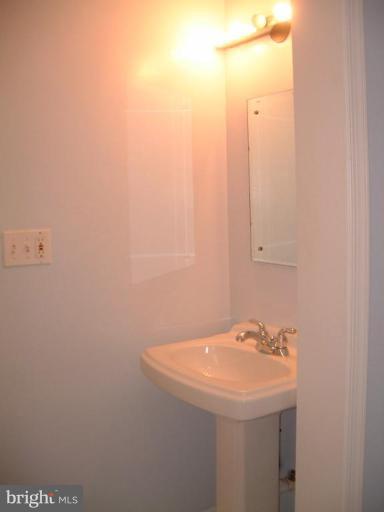 13919 Overton Lane Silver Spring, MD 20904 - Photo 15 of 16 a bathroom with a sink and a mirror