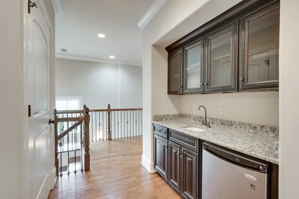 a kitchen with a sink a stove and cabinets