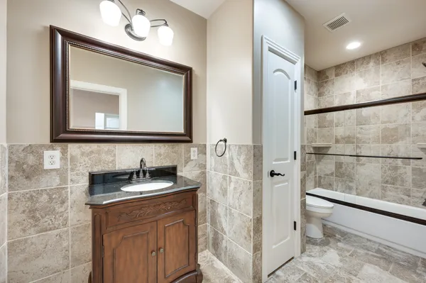 a bathroom with a sink a mirror and a shower