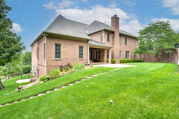 a view of a house with a yard and garage