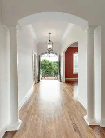 a view of a room with wooden floor and chandelier