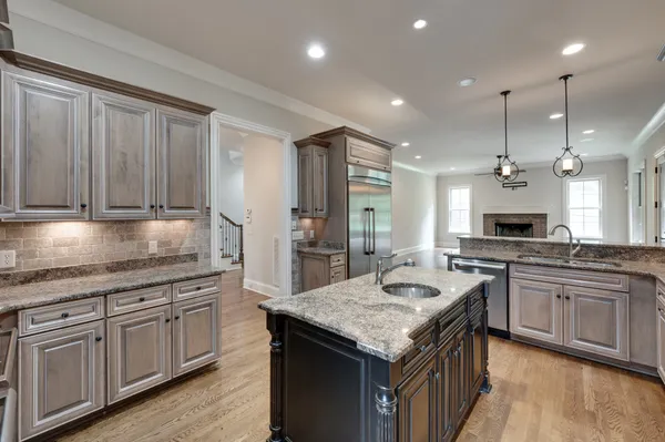 a kitchen with granite countertop kitchen island white cabinets and stainless steel appliances