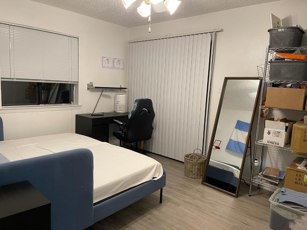 2510 San Gabriel Street, Unit 301 Austin, TX 78705 - Photo 12 of 22 a bedroom with a bed a flat screen tv and dresser