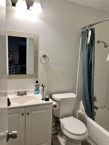 a bedroom with a bed and a chair