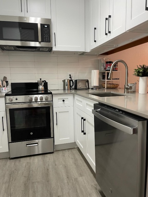 2510 San Gabriel Street, Unit 301 Austin, TX 78705 - Photo 5 of 22 a kitchen with stainless steel appliances a sink a stove and microwave