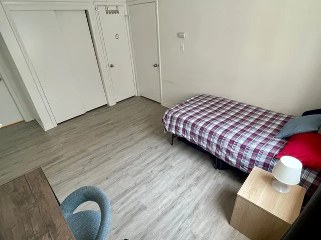 a bedroom with a bed and a window