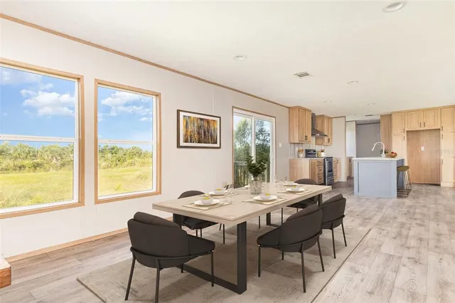 a view of a dining room with furniture window and wooden floor