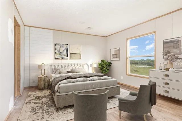 a bedroom with a bed and a large window