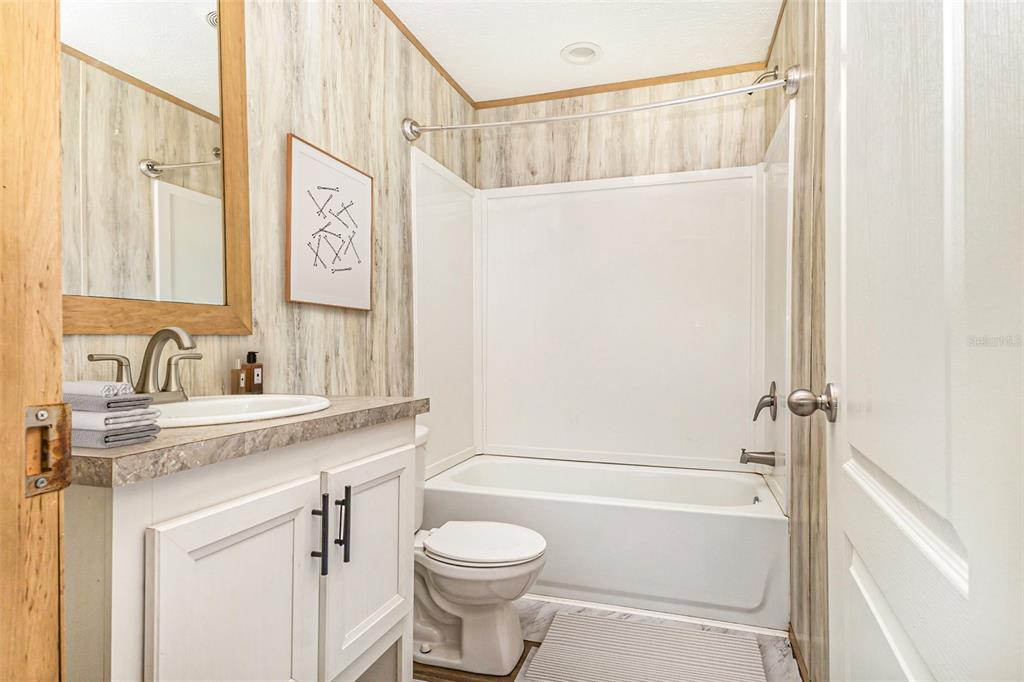 16423 Northwest 262nd Street Okeechobee, FL 34972 - Photo 25 of 30 a bathroom with a sink a toilet and a bathtub