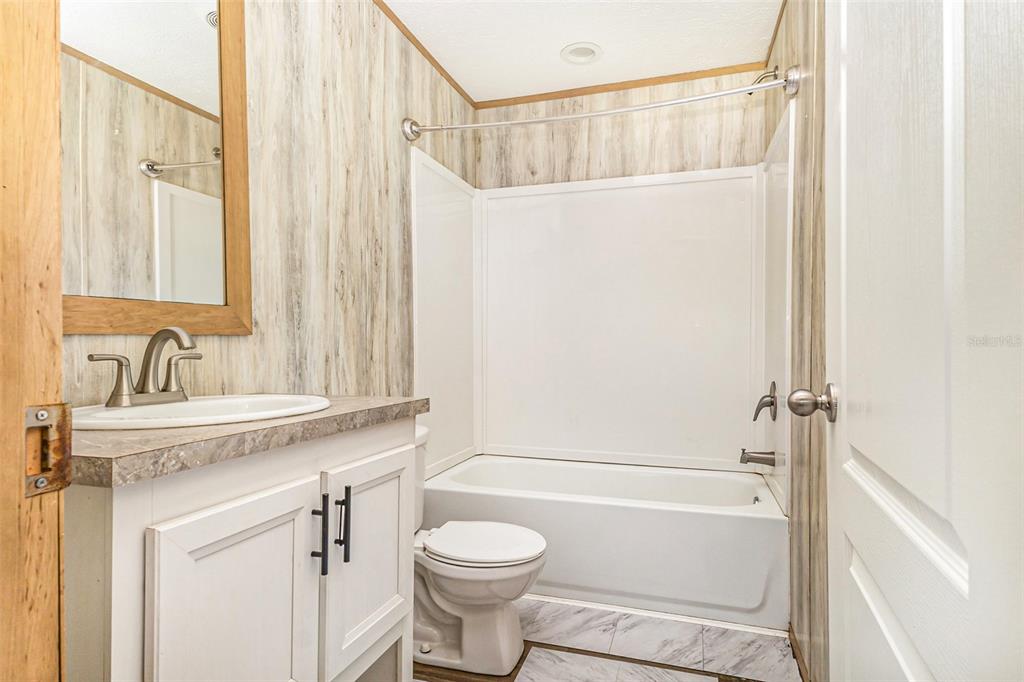 16423 Northwest 262nd Street Okeechobee, FL 34972 - Photo 26 of 30 a bathroom with a sink a toilet and a bathtub