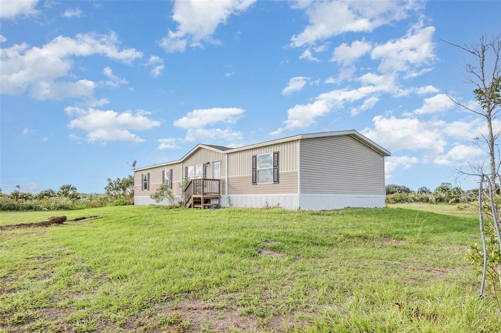 16423 Northwest 262nd Street Okeechobee, FL 34972 - Photo 30 of 30 a view of a house with a yard