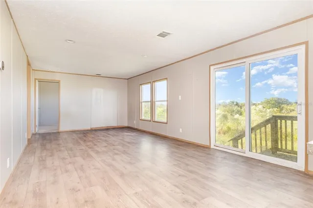 a view of an empty room with large windows