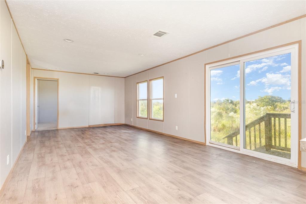 16423 Northwest 262nd Street Okeechobee, FL 34972 - Photo 6 of 30 a view of an empty room with large windows