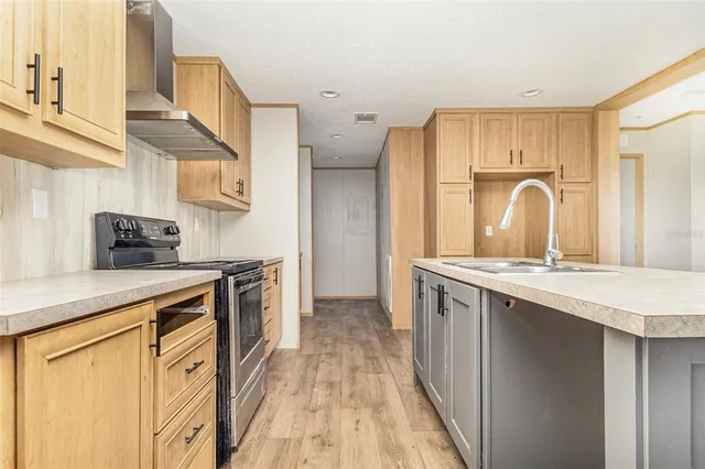 a kitchen with stainless steel appliances granite countertop a sink and a stove