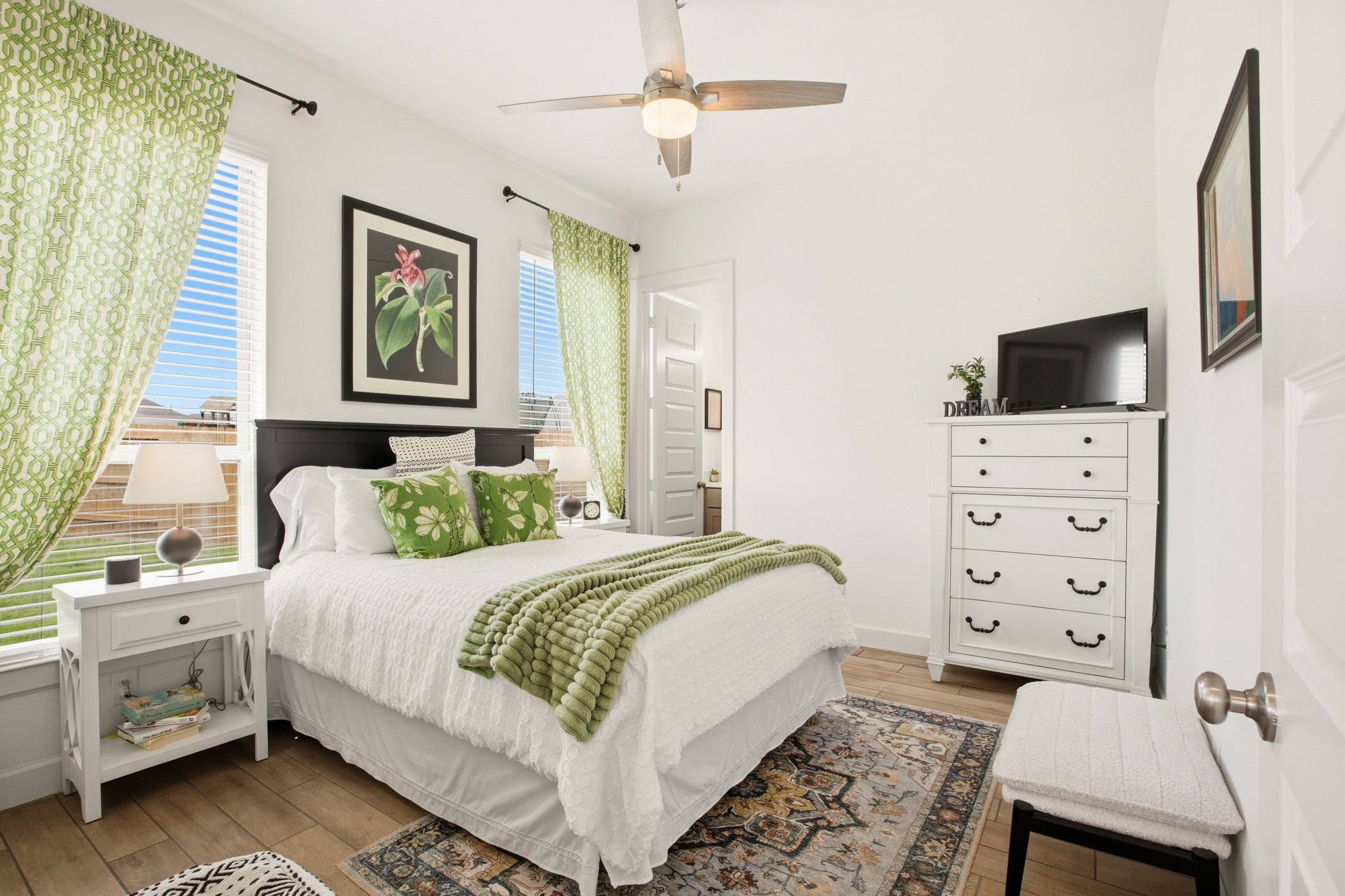5422 Farm Hill Way Fulshear, TX 77406 - Photo 22 of 50 a bedroom with a bed and a flat screen tv