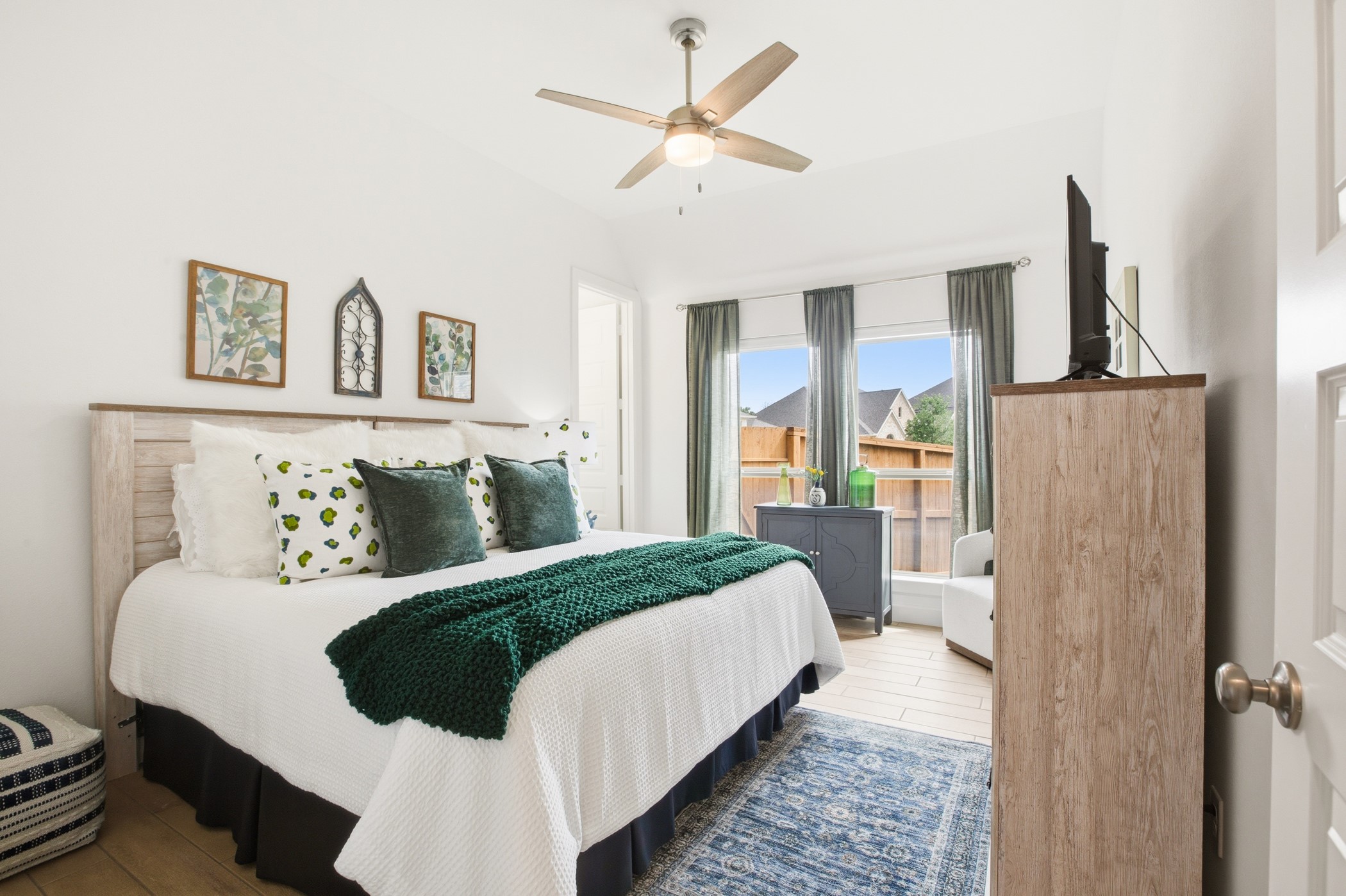 5422 Farm Hill Way Fulshear, TX 77406 - Photo 26 of 50 a bedroom with a bed painting on wall and a large window