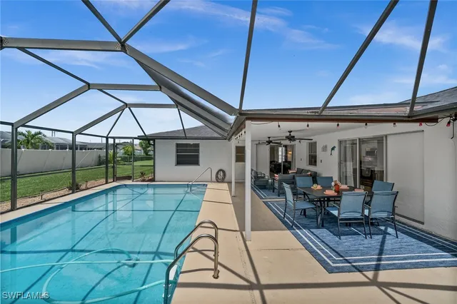a view of a patio with table and chairs under an umbrella