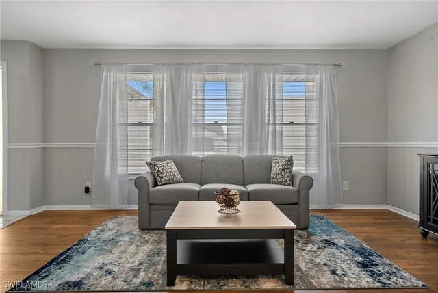 a living room with furniture and a rug